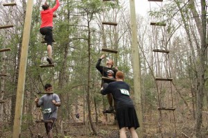 Athletes climb a rope ladder at the Shale Hill course.