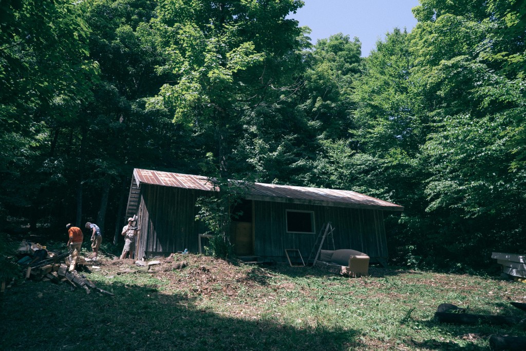 Workers clear out the Bell Gates Cabin this summer. Photo by Kyle Crichton